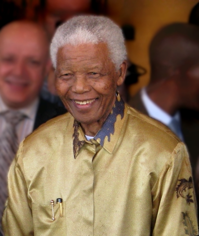 Image of Nelson Mandela, wearing a gold shirt, 2008.
